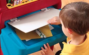 closeup of child opening desk