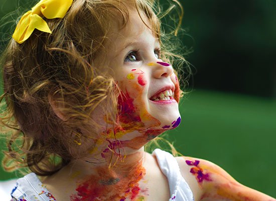 toddler covered in paint